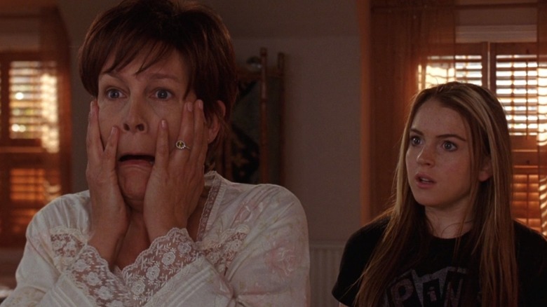 Jamie Lee Curtis clutching her face in horror next to a startled Lindsay Lohan.