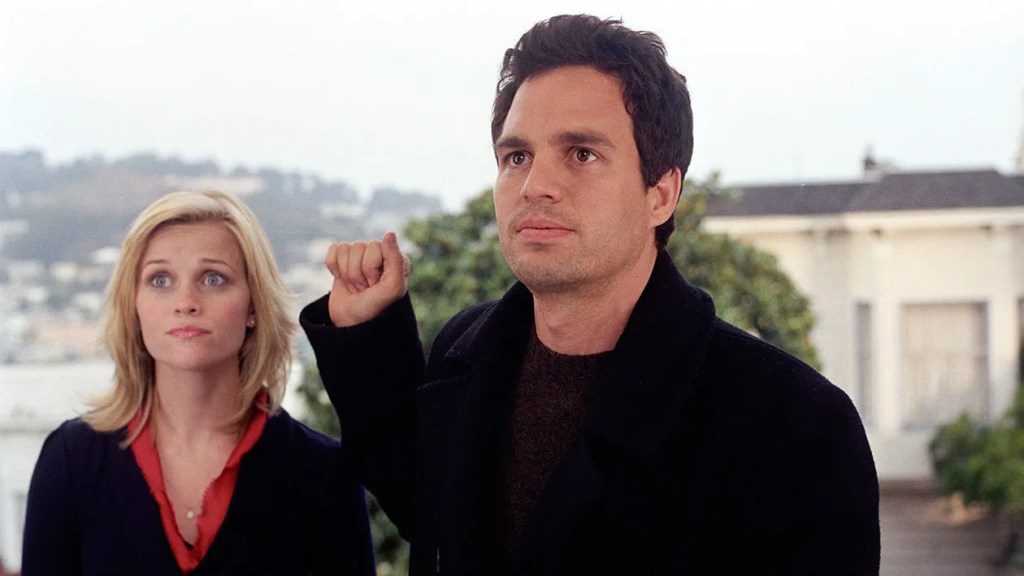 Reese Witherspoon and Mark Ruffalo standing outdoors with the San Francisco hills behind them.