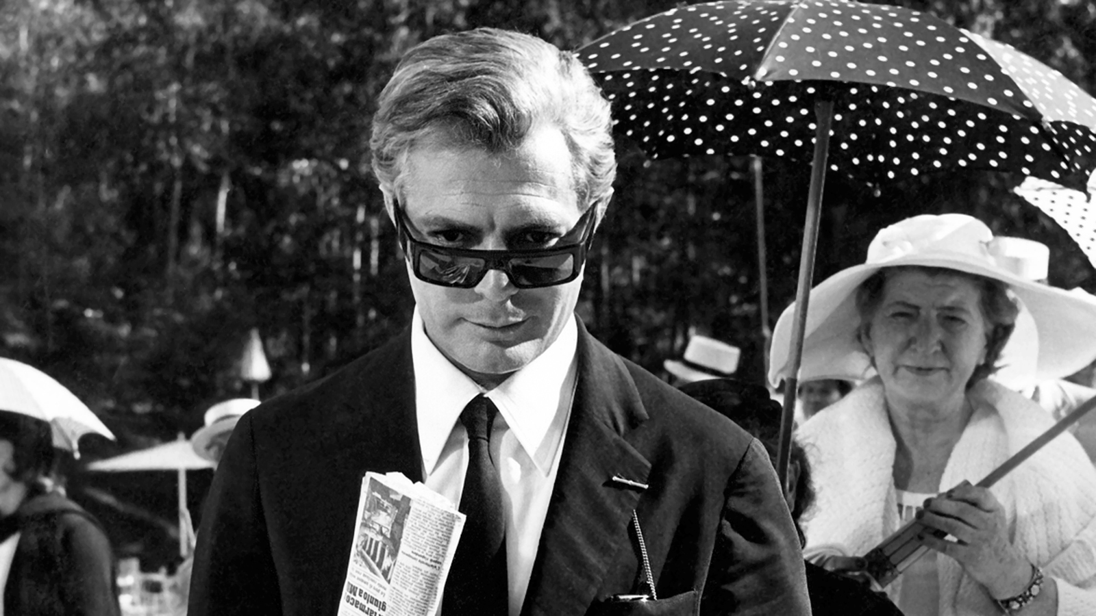 Marcello Mastroianni in glasses in a black-and-white scene from 8½.