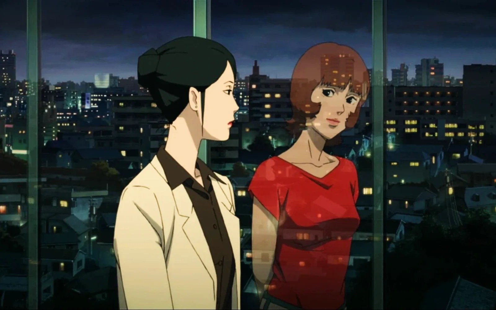 Dr. Atsuko Chiba in a white jacket beside her alter ego Paprika, reflected in a window over the city at night in Paprika.