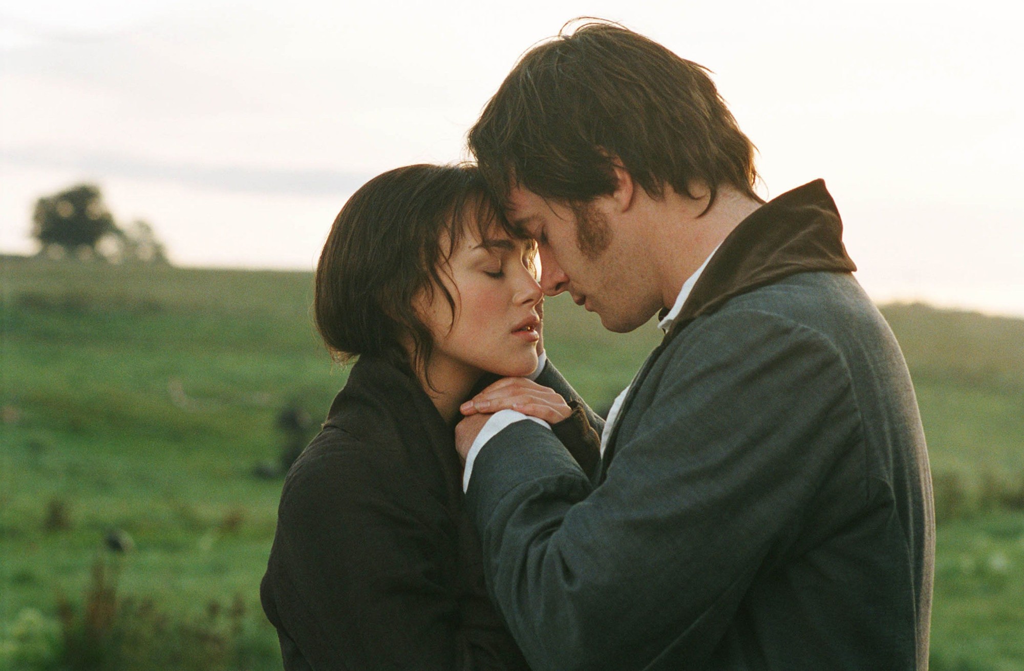 Keira Knightley and Matthew Macfadyen standing forehead to forehead in a misty green field at dawn in Pride & Prejudice (2005).